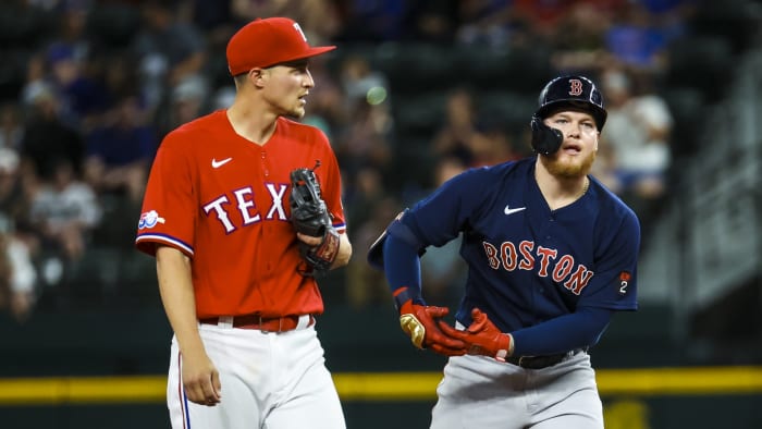 May 13, 2022; Arlington, Texas, USA; Boston Red Sox left fielder Alex Verdugo (99) celebrates in front of Texas Rangers shortstop Corey Seager (5) after hitting an rbi double during the sixth inning at Globe Life Field.